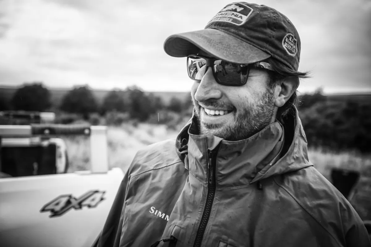 A smiling PRG guide in a cap and sunglasses