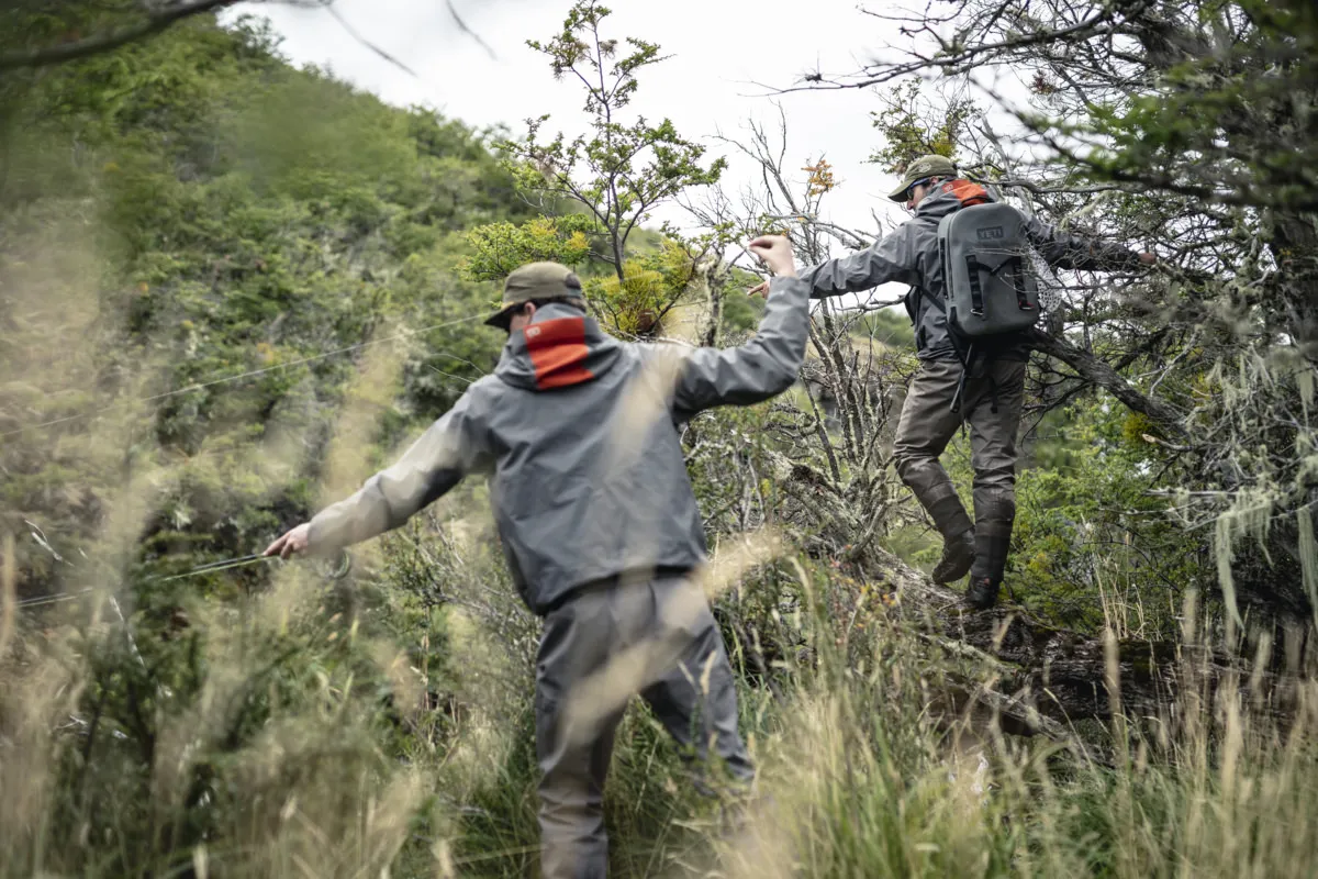 Two PRG anglers hiking through brush to the river