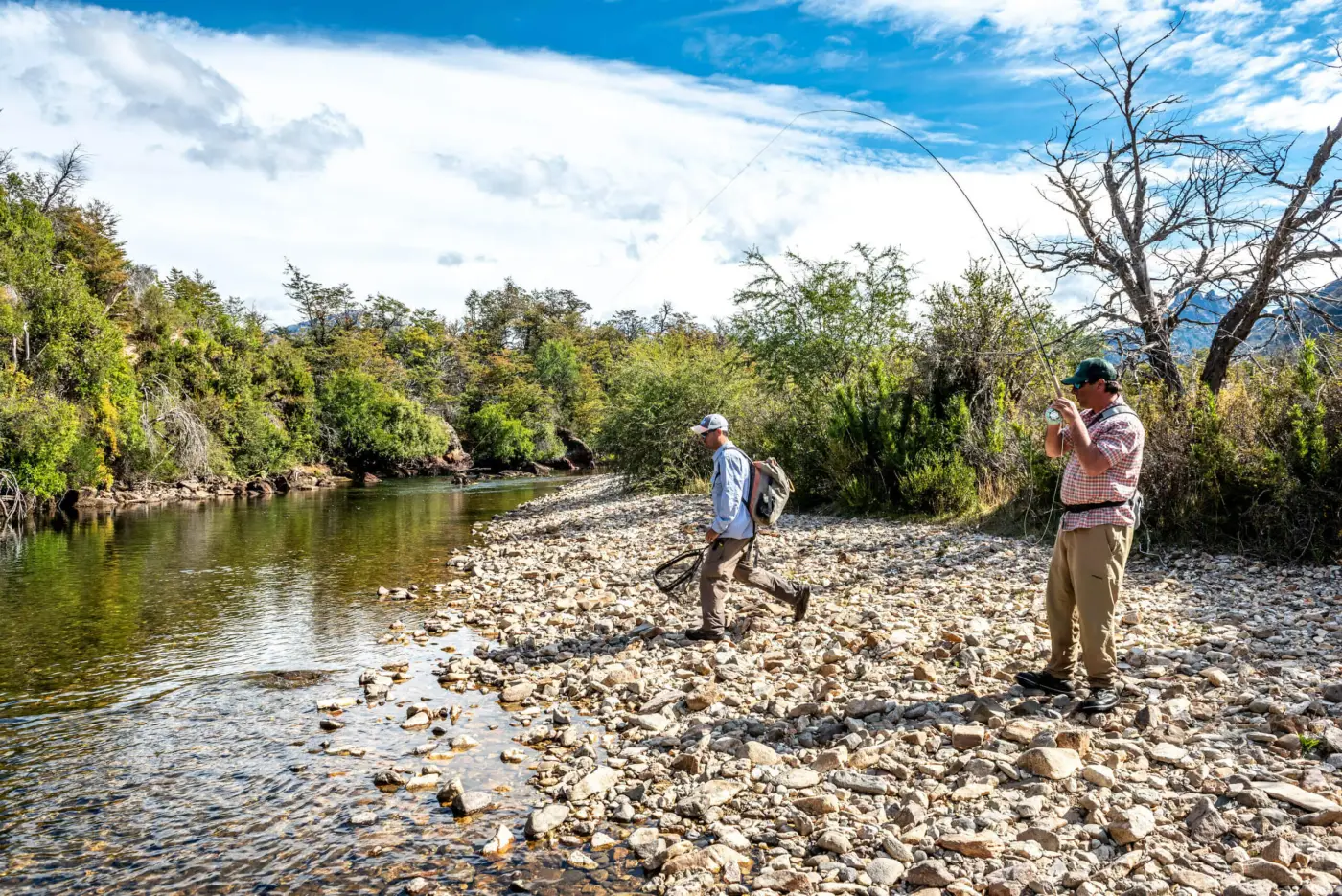 Two anglers wading a clear Patagonian river